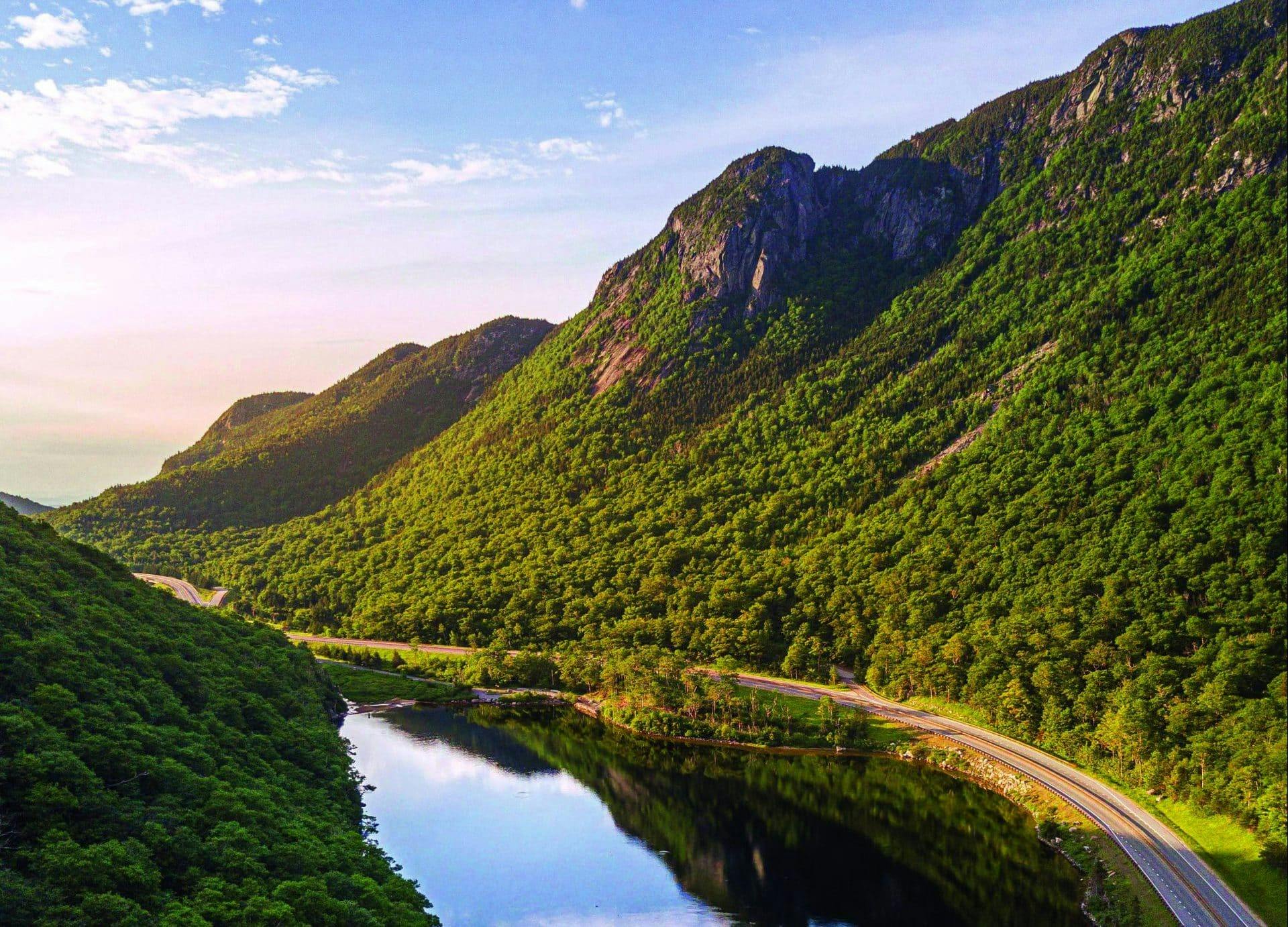 https://newengland.com/wp-content/uploads/2023/05/Scenic-Drive-in-the-White-Mountains-of-New-Hampshire-3-scaled-e1685449328144.jpg